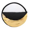 A circular photography reflector with gold, black, and white surfaces. Podgląd zdjęcia produktu