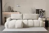 A cream-colored sectional sofa in a living room setting. Produktbild-Vorschau
