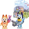 A product shot of Bluey figures and accessories in their packaging, with one figure outside the packaging. Voir les images du produit