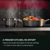 A kitchen scene with two pots on a stovetop, with steam rising. Text describes a feature of a kitchen appliance. Voir les images du produit