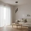 A modern living room with a sofa, coffee table, and a pendant light. Podgląd zdjęcia produktu