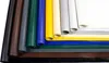 Several rolls of colored PVC tarpaulin are displayed side-by-side, with some unrolled to show the material. Voir les images du produit