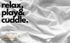 A white, wrinkled fabric background with text overlay and a certification logo. Produktbild-Vorschau