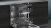The interior of a dishwasher with racks extended. Produktbild-Vorschau