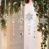 Christmas ornaments hanging from greenery over a doorway. Náhľad obrázku produktu