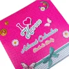 A close-up view of a pink advent calendar with polka dots and various decorative elements. Produktbild-Vorschau