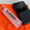 A bottle of WHOOSH screen cleaner and a smartphone are placed on an orange microfiber cloth. Náhled obrázku produktu