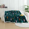A cozy blanket with a Christmas theme is draped over a sofa. Produktbild-Vorschau