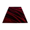 A rectangular rug with a red and black abstract pattern, presented on a white background. Anteprima dell’immagine prodotto
