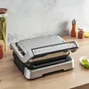 A kitchen counter with a grill and some spices. Produktbild-Vorschau