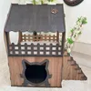A two-story cat house made of wood, with a cat-shaped entrance and a small staircase. Voir les images du produit