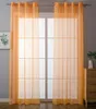 Two orange sheer curtains hanging in front of a window. Produktbild-Vorschau
