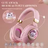 A pair of pink pet-themed wireless headphones with cute cat decorations, presented against a soft pink and light gray background with marketing text and feature icons. Voir les images du produit
