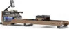 A wooden rowing machine with a digital display, shown against a white background. Produktbild-Vorschau