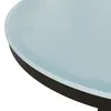 A close-up view of the edge of a round table with a textured light blue glass top and a black frame. Náhľad obrázku produktu