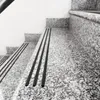 Close-up view of granite stairs with black anti-slip strips. Produktbild-Vorschau
