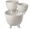 A white, tiered planter with a textured design and three legs. Produktbild-Vorschau