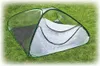 A pop-up greenhouse tent on a grassy lawn. Náhled obrázku produktu
