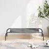 A gray elevated dog bed with a steel frame is shown in a room with a plant and toys. Náhľad obrázku produktu