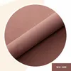 A close-up of rolled fabric with a part of it folded over, displayed in a circular frame. Anteprima dell’immagine prodotto