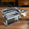 A chrome pasta maker sits on a wooden table. Produktbild-Vorschau