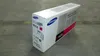 A Samsung toner cartridge box is placed on a concrete floor. Produktbild-Vorschau