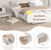 A baby changing table is shown in a bedroom setting, with close-up shots highlighting storage features. Produktbild-Vorschau