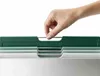 A hand is shown interacting with a set of cutting boards in a holder. Anteprima dell’immagine prodotto