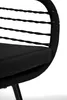 A close-up view of a black chair, focusing on the woven rope and cushion. Produktbild-Vorschau