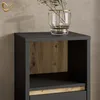 A close-up view of a modern furniture piece with a dark gray exterior and a wood-grain accent panel. Voir les images du produit