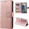 A collage of images showing a rose gold mandala-embossed flip phone case for a Samsung Galaxy A14 4G/5G. Produktbild-Vorschau