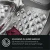 Close-up view of the inside of a washing machine drum with water droplets and a piece of clothing. Produktbild-Vorschau