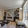 A modern living room with a fireplace, bookshelves, and seating. Podgląd zdjęcia produktu