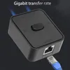 A black network switch with a blue ethernet cable plugged into it, set against a dark background. Text indicating 'Gigabit transfer rate' is visible at the top. Anteprima dell’immagine prodotto