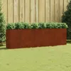 A rectangular Corten steel planter filled with green plants, placed on a lawn in front of a wooden fence. Anteprima dell’immagine prodotto