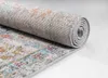 A close-up view of a rolled-up rug, showing its textured surface and intricate pattern. Náhled obrázku produktu