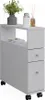 A white cabinet with drawers and an open shelf, decorated with a plant, a jar, and a diffuser. Náhľad obrázku produktu