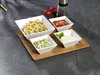 A set of four white square bowls filled with different dips and snacks, arranged on a wooden tray. Produktbild-Vorschau