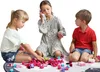 Three children are playing with building blocks on a rug. Produktbild-Vorschau