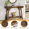 A rustic brown console table with a shelf, decorated with a vase of plants, books, and hourglasses. Insets highlight product features like finish, thickness, and adjustable feet. Podgląd zdjęcia produktu