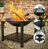 A fire pit with burning logs in a garden setting. Produktbild-Vorschau