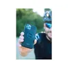 A person holding a phone case with a cyclist in the background. Voir les images du produit