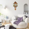 A living room with a cuckoo clock on the wall and a comfortable armchair. Náhľad obrázku produktu