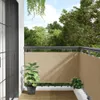 A balcony with a beige privacy screen installed along the railing, featuring two potted plants. Náhľad obrázku produktu
