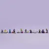 A line of LEGO minifigures standing on a purple background. Náhled obrázku produktu