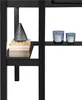 A close-up shot of books and candles on a black shelf. Produktbild-Vorschau