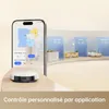 A robot vacuum cleaner is shown next to a smartphone displaying its app interface, with stylized room representations in the background. Produktbild-Vorschau
