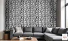 A living room with a sectional sofa in front of a textured gray wall. Produktbild-Vorschau