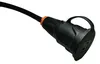 A close-up shot of an electrical adapter cable with a black rubber hose and a black plastic connector with an orange ring. Produktbild-Vorschau