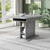 A dining table in a room with a window and plants. Produktbild-Vorschau
